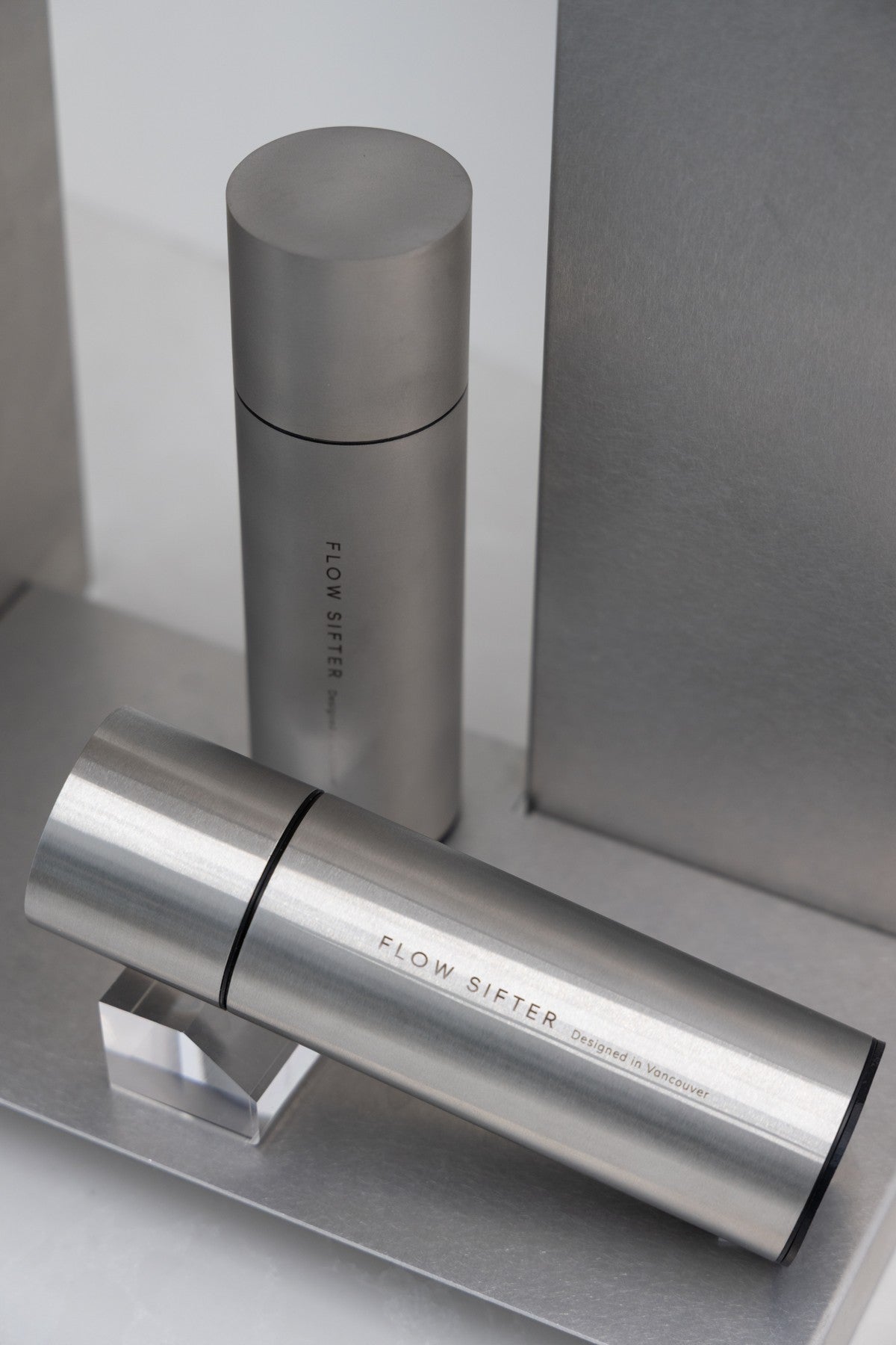 Satin and Brushed Flow Sifters arranged on a stainless steel shelf