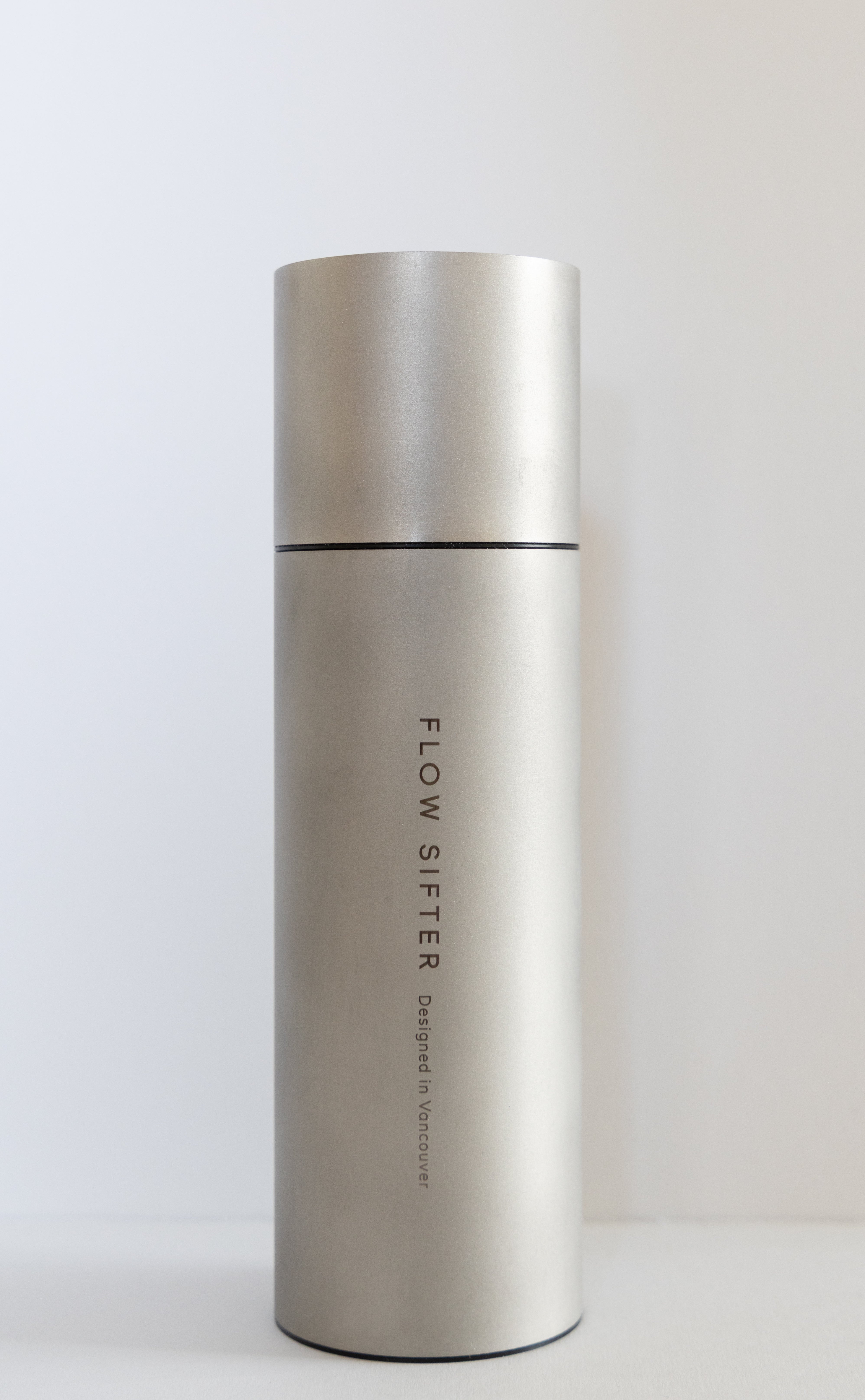 Flow Sifter in bead-blasted matte stainless steel with its vertical logo